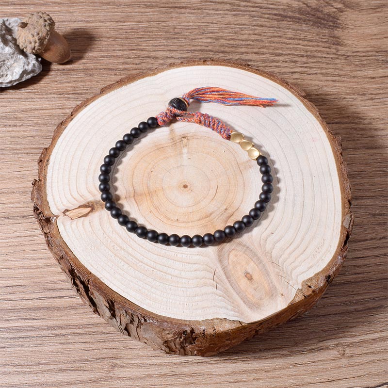 Braccialetto fatto a mano in onice nero tibetano con nappa Buddha Stones - Image 3