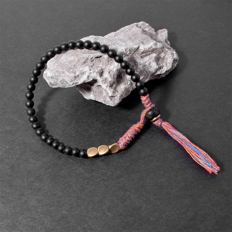 Braccialetto fatto a mano in onice nero tibetano con nappa Buddha Stones - Image 5